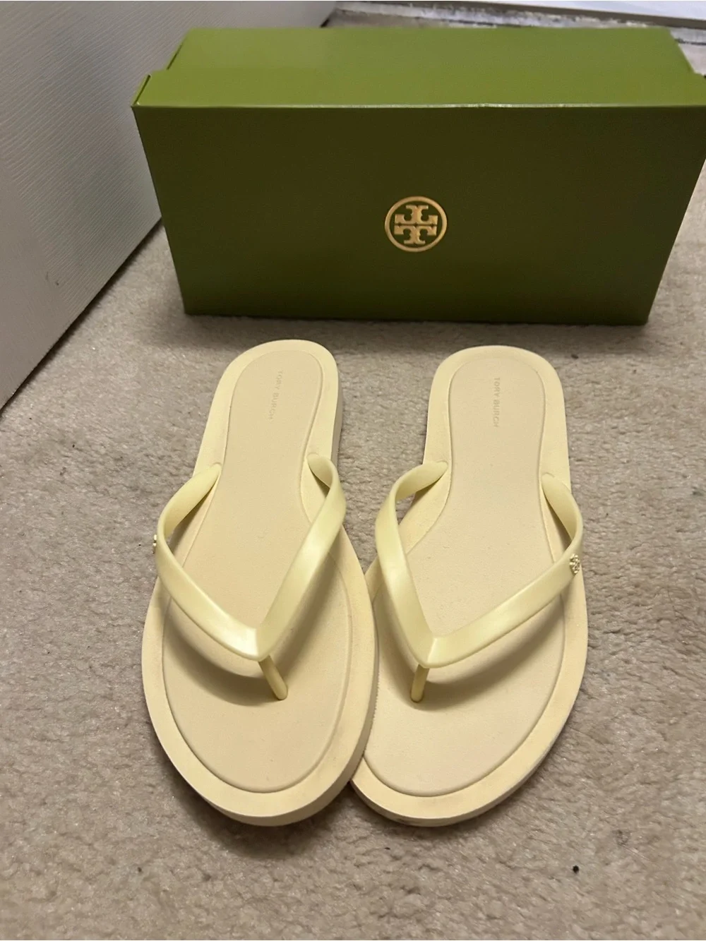 TORY BURCH KIRA padded flip flops in light yellow.